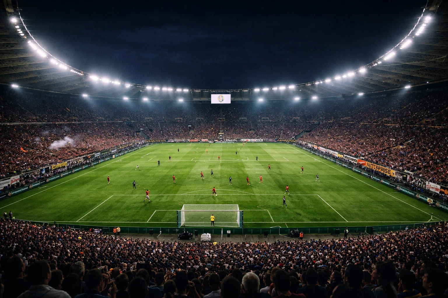 Stadio di calcio italiano durante una partita serale con luci accese